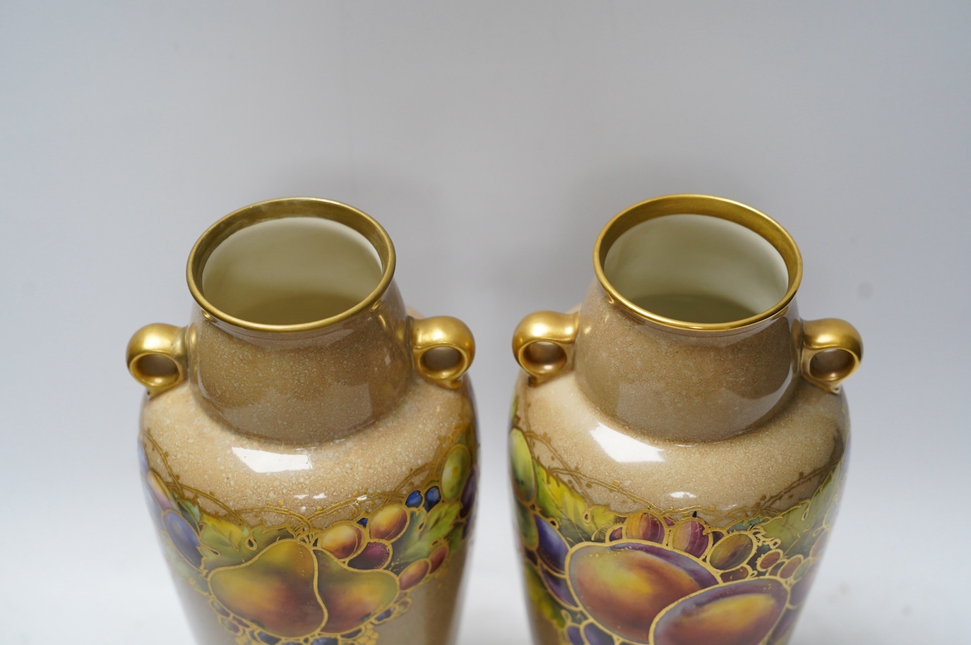 A pair of Worcester vases, decorated with fruit and berries, model number 2768, 26cm. Condition - good